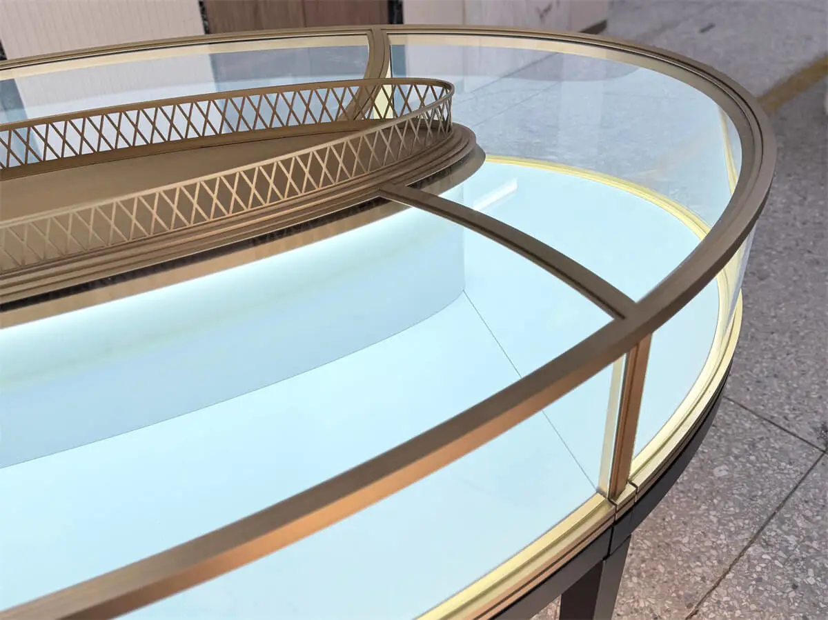 Detail of Luxury Oval Island Jewelry Showcase with CRI 95+ LED lighting and premium brass tray for jewelry display.